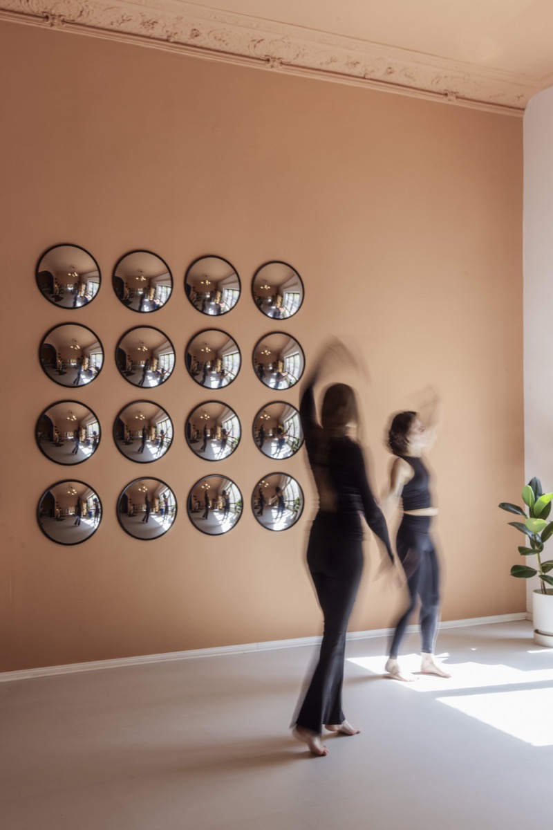 Two members moving in front of the mirror wall
